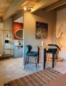 a dining room with a table and two chairs at Maison Bruno Di Salvio in Les Vans