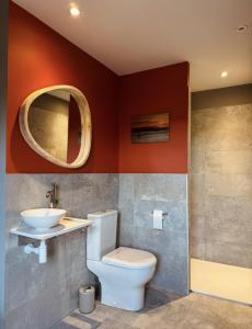 a bathroom with a toilet and a sink and a mirror at Maison Bruno Di Salvio in Les Vans +33 photos