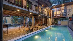 a house with a swimming pool in front of a building at Barren House in Hiriketiya