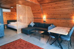a living room with a couch and a table and a bed at Akcasehir Sosyal Tesisleri in Akçakoca