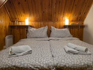 a large bed with two pillows on top of it at Chalupa Lázeňka in Pernink