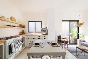a kitchen with a table and a dining room with a couch at Outsite Los Cabos - Entire 4-Bedroom Home in San José del Cabo +31 photos
