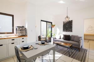 a kitchen and living room with a table and a couch at Outsite Los Cabos - Entire 4-Bedroom Home in San José del Cabo