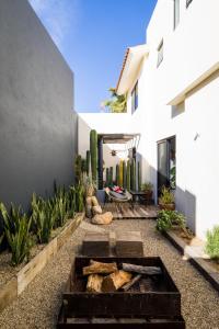 a backyard with a fire pit in the middle of a house at Outsite Los Cabos - Entire 4-Bedroom Home in San José del Cabo