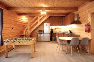 a kitchen with a table with a chess board at Chata pri Kaštieli - 2 E-bikes in Necpaly