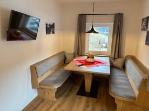 a dining room with a table and a window at Bed and Breakfast Iman in Santa Cristina Gherdëina