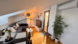 a living room with a couch and a table at Apartamentos Suites Olmedo in Olmedo