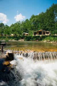 a waterfall in the middle of a river at Trava Bungalow in Korostov
