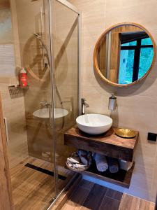 a bathroom with a sink and a mirror at Trava Bungalow in Korostov