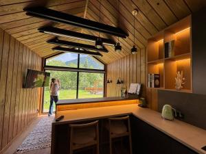 a person taking a picture of a bar in a cabin at Trava Bungalow in Korostov +21 photos