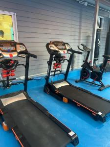 a gym with two tread machines on the floor at Space House Hotel Phuket in Rawai Beach