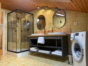 a bathroom with a sink and a washing machine at das Landblick in Sillian
