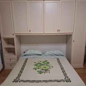 a bedroom with a bed with white cabinets at I 3 FRATELLI in Foligno