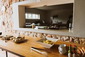 a table with a bowl of food and a mirror at Matatane Camp - Babanango Game Reserve in Babanango +21 photos