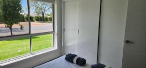 a room with a shower and a window at Room In Dubbo With Queens Beds in Dubbo