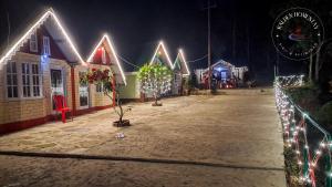 a group of houses decorated with christmas lights at Kalden Homestay Sinji in Kalimpong +8 photos