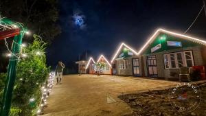 a house decorated with christmas lights in a yard at Kalden Homestay Sinji in Kalimpong