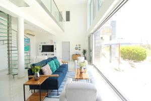 a living room with a blue couch and a table at Ocean View Mansion 8 min to Palm Beach in Noord