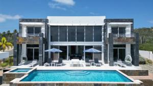 a villa with a swimming pool and a resort at Ocean View Mansion 8 min to Palm Beach in Noord +53 photos