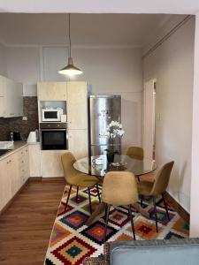 a kitchen with a dining room table and chairs at Urban art House in Eleusis
