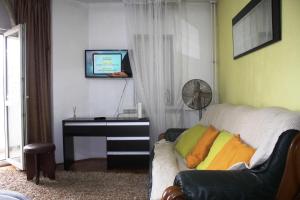 a living room with a couch and a piano at Decebal 1 Premium apartment in Bucharest