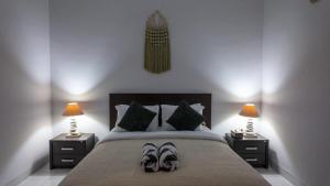 a bedroom with a bed with a pair of shoes on it at 3BR Private Pool Villa in Central Seminyak - Walk to Cafés & Shops in Seminyak +35 photos
