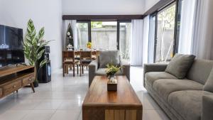 a living room with a couch and a table at 3BR Private Pool Villa in Central Seminyak - Walk to Cafés & Shops in Seminyak