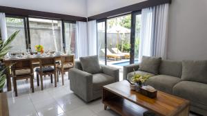 a living room with a couch and a table at 3BR Private Pool Villa in Central Seminyak - Walk to Cafés & Shops in Seminyak