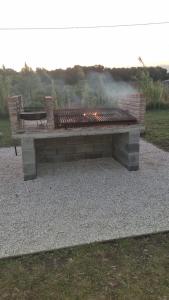 a stone bench with a picnic table in a park at Altos de Arenas in Miramar