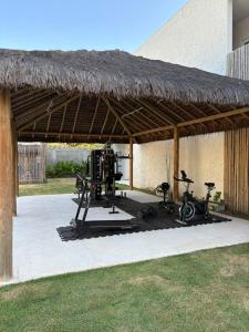 a pavilion with a gym with a bike and exercise equipment at Apartamento A03 - Curimã in Passo de Camarajibe
