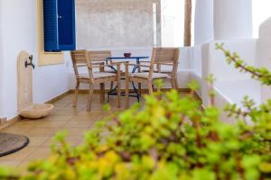 a table and chairs on the balcony of a house at Folia in Agia Marina +10 photos