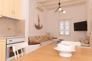 a kitchen and living room with a table and chairs at Folia in Agia Marina