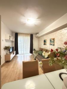 a living room with a couch and a table at Luxury Apartments Newton by GLAM - Parking Option in Iaşi