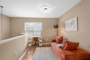 a living room with a couch and a window at Tusculum Hilltop Haven For 8 in Cincinnati