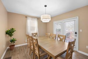 a dining room with a wooden table and chairs at Tusculum Hilltop Haven For 8 in Cincinnati