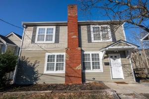 a house with a brick chimney on top of it at Tusculum Hilltop Haven For 8 in Cincinnati