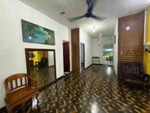 a living room with a couch and a wooden floor at OYO 91270 Sabsa Homestay in Kuching
