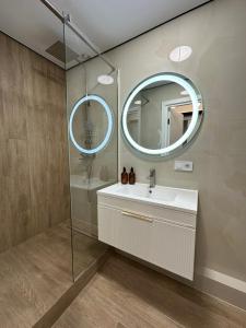 a bathroom with a sink and a mirror at ЖК Сонячна Тераса in Ternopil +13 photos