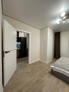 a bedroom with white walls and a bed in it at ЖК Сонячна Тераса in Ternopil