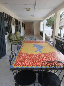 a dining room with a table and chairs and a room with a tableablish at Chez Andre in Ngaparou