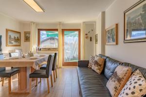 a living room with a couch and a table at Trilo Ciasa Brìma in Carano