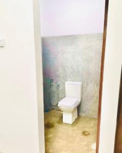 a bathroom with a toilet in the corner of a room at Pilgrims Nature Villa in Ahangama +29 photos