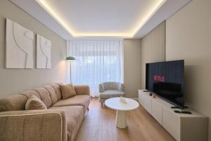 a living room with a couch and a tv at BSY Flats Well Decorated Modern Apartments With 2BR, 3BR Options in Istanbul