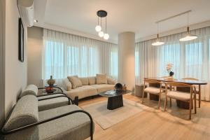 a living room with a couch and a table at BSY Flats Well Decorated Modern Apartments With 2BR, 3BR Options in Istanbul