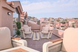 a balcony with chairs and a table on a balcony at BSY Flats Well Decorated Modern Apartments With 2BR, 3BR Options in Istanbul