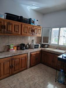 a kitchen with wooden cabinets and a counter top at Chez Andre in Ngaparou +14 photos