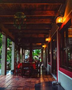 a porch of a house with a table and chairs at Goba Lodge & Rest Camp in Gobabis