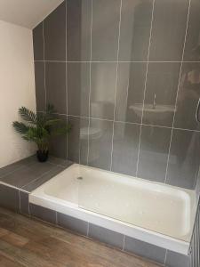 a bathroom with a bath tub and a sink at The Turret, Central Apartment in Hebden Bridge