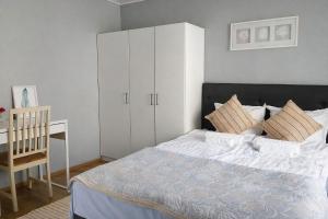 a bedroom with a bed and a white cabinet at Lumi & Luonto - Entire 100 sqm 3-BR house with private wood fired sauna in Oulu
