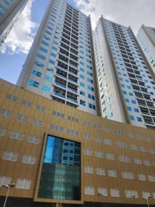 a tall building with two tall buildings at Apartment in ajman in Ajman 